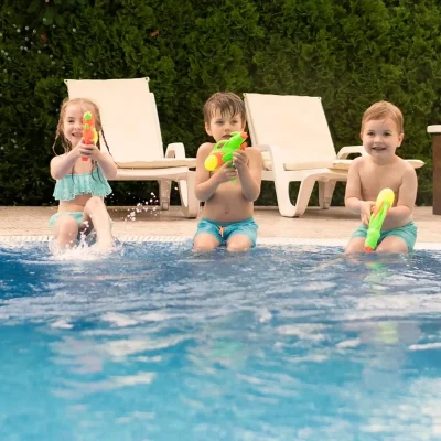 childrens-playing-with-water-guns-while-pool_2_11zon_2_11zon